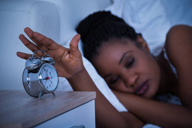 istock Woman Turning Off The Alarm Clock 917037384