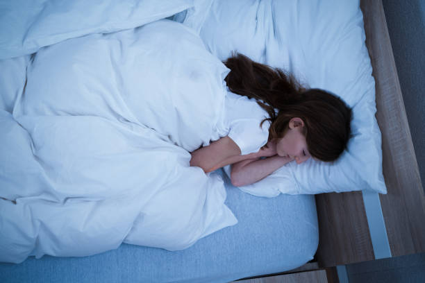 istock Girl Sleeping On Cozy Bed 917037392