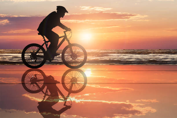istock Silhouette Of A Cyclist At Beach 917037484