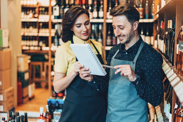 istock Wine shop owners discussing a checklist 917043022