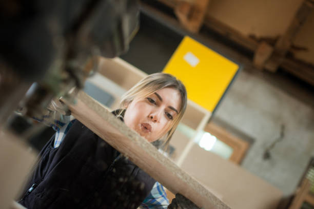 istock Pretty Young Woman Drilling Plank 917043164