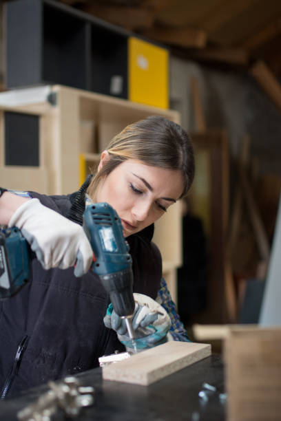 istock Pretty Young Woman Drilling Plank 917043612