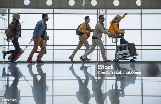 Cheerful Friendly Team Are Racing To Their Gate Stock Photo - Download Image Now - Airport, Travel, Friendship