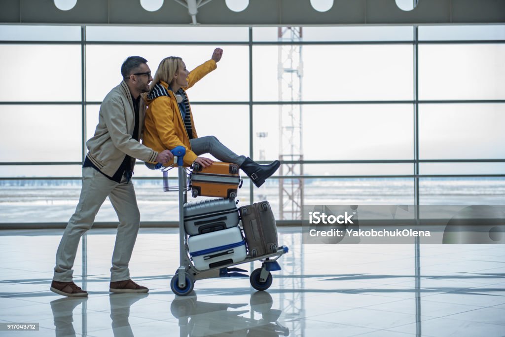 Optimiste, mâle et femelle sont promènent à la zone de départ - Photo de Aéroport libre de droits