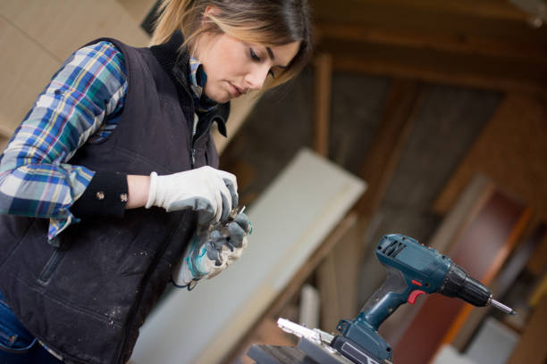 istock Pretty Young Woman Drilling Plank 917043862