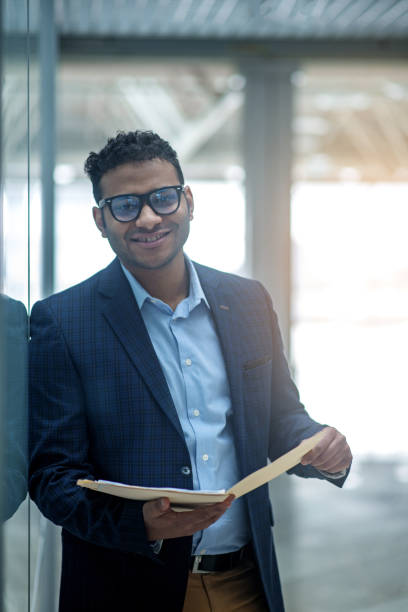 istock Confident experienced entrepreneur is keeping papers with smile 917043968