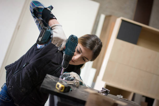 istock Pretty Young Woman Drilling Plank 917045984