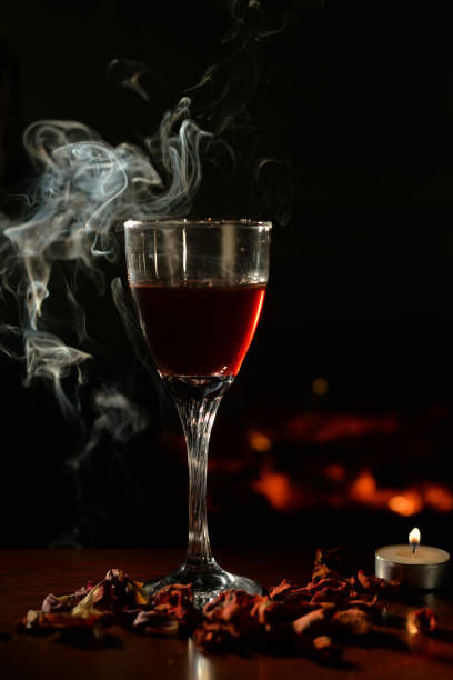 istock Romantic scene with wine Glass and Fireplace 917046556