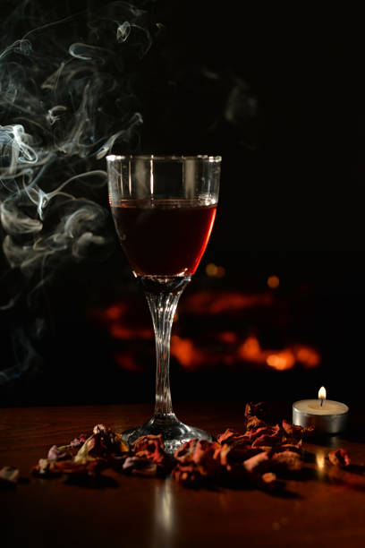 istock Romantic scene with wine Glass and Fireplace 917046574