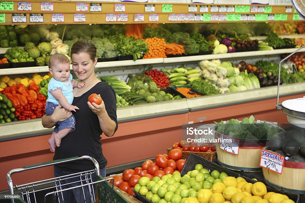 Woman with baby in grocery store  Baby - Human Age Stock Photo