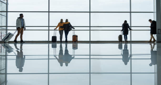 istock Men and women are spending time at terminal with suitcases 917048786