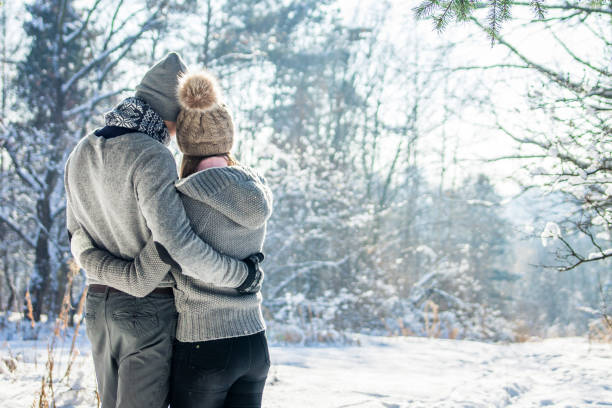 istock Couple hugs in winter forest 917052414