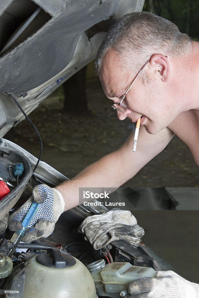 The man repairs car  School Bus Stock Photo