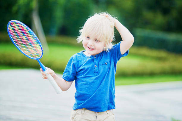 istock Little boy playing badminton on the playground 917053792