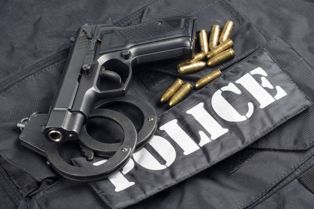 istock Police concept - handgun on black uniform background 917053840