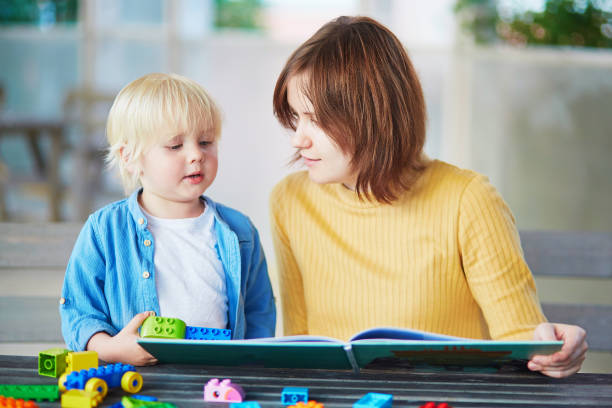 istock Young mother reading book to her son 917054080