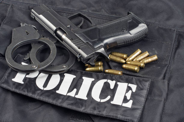 istock Police concept - handgun on black uniform background 917054094