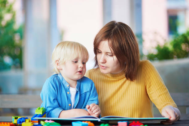 istock Young mother reading book to her son 917055666