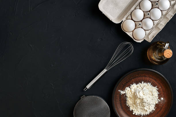 istock Preparation cooking baking kitchen table brown dishes ware fresh grocery different ingredients: eggs, flour, oil, stuff top view 917056162
