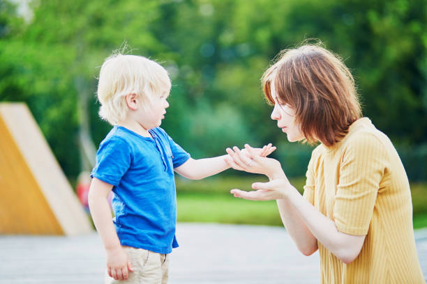 Mother comforting her son after he injured his hand Mother comforting her crying son after he injured his hand sliver stock pictures, royalty-free photos & images