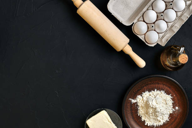 istock Preparation cooking baking kitchen table brown dishes ware fresh grocery different ingredients: eggs, flour, oil, stuff top view 917056658