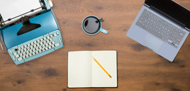 istock Electric typewriter and laptop on wood background 917056846