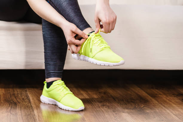 istock Woman putting sport shoes 917059468