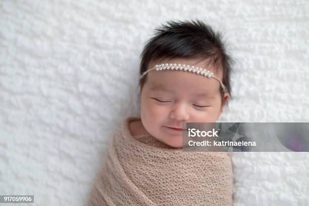 Smiling Baby Girl Wrapped In A Beige Swaddle Stock Photo - Download Image Now - Baby - Human Age, Latin American and Hispanic Ethnicity, Sleeping