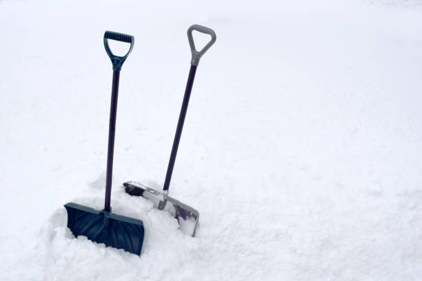 istock Snow Shovel in Snow Pile During Cold Winter White Snowstorm 917063110