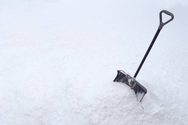 istock Snow Shovel in Snow Pile During Cold Winter White Snowstorm 917063112