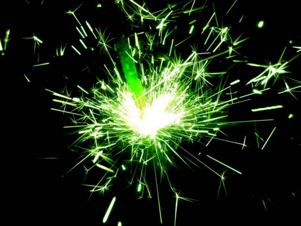 istock Christmas Bengal lights with bright sparks on a black background closeup 917063600