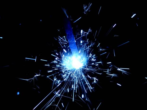istock Christmas Bengal lights with bright sparks on a black background closeup 917063610