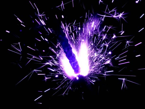 istock Christmas Bengal lights with bright sparks on a black background closeup 917063618