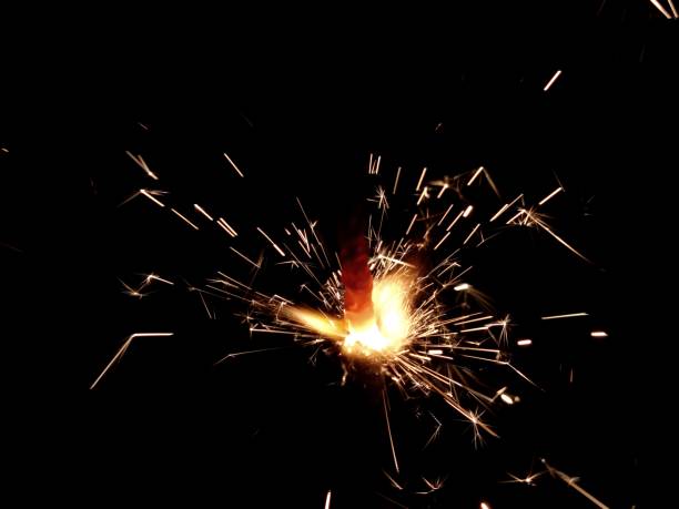 istock Christmas Bengal lights with bright sparks on a black background closeup 917063632