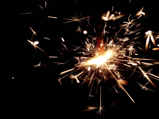 istock Christmas Bengal lights with bright sparks on a black background closeup 917063642