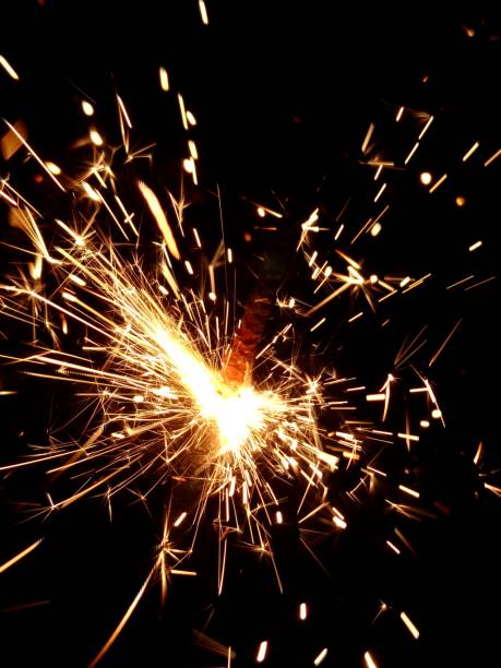 istock Christmas Bengal lights with bright sparks on a black background closeup 917063652