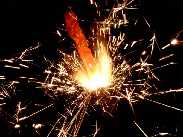 istock Christmas Bengal lights with bright sparks on a black background closeup 917063658