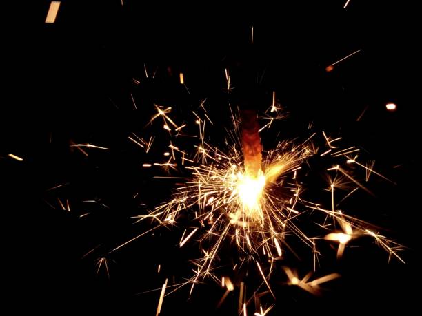 istock Christmas Bengal lights with bright sparks on a black background closeup 917063674