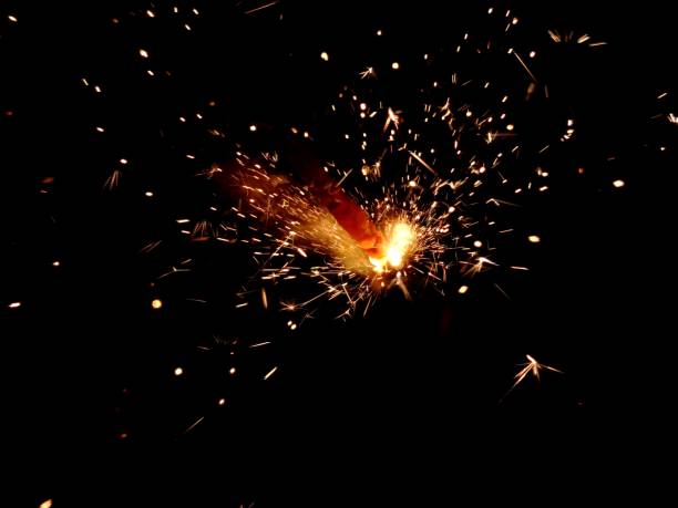 istock Christmas Bengal lights with bright sparks on a black background closeup 917063686