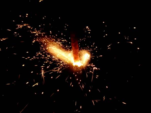 istock Christmas Bengal lights with bright sparks on a black background closeup 917063694
