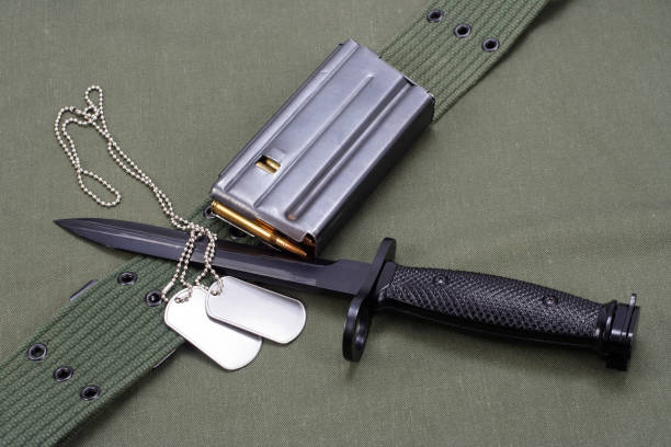 istock M16 rifle bayonet on uniform background 917064572