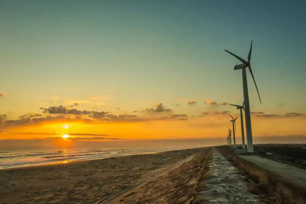 Morning glow or sunset, sea and windmill. Beautiful nature.