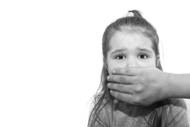 woman holding finger in front of mouth , showing to be quiet