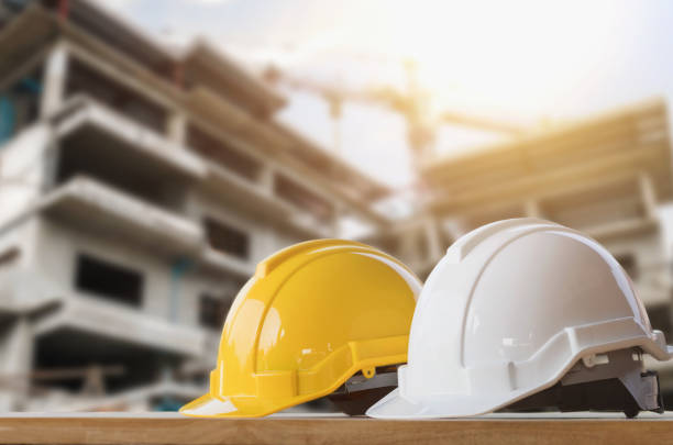istock yellow and white helmet safety in construction site 917076726