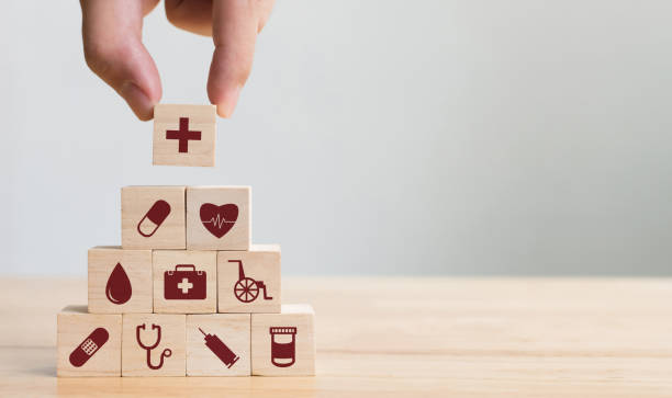hand arranging wood block stacking with icon healthcare medical, insurance for your health concept - projeto social imagens e fotografias de stock