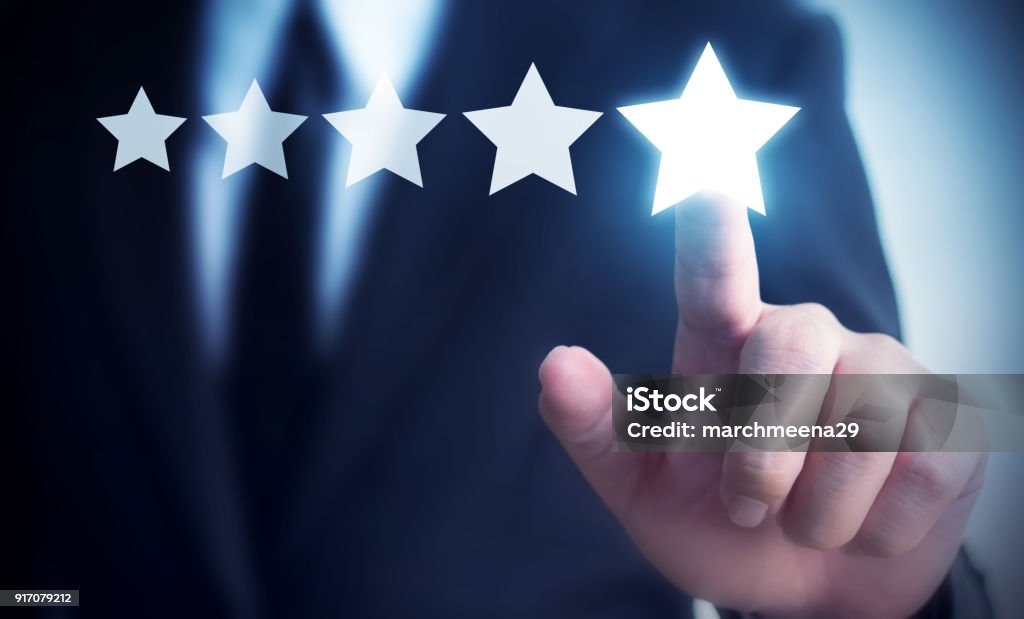 Businessman hand touching five star symbol to increase rating of company concept, Copy space background for your title Quality Stock Photo