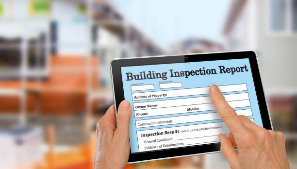 Buiding Inspector completing an inspection form on computer tablet stock photo