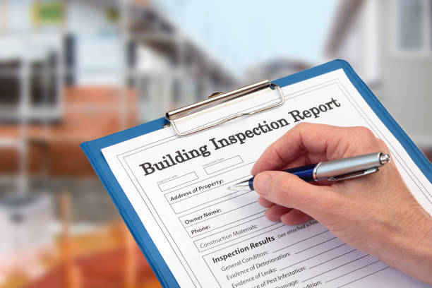 Buiding Inspector completing an inspection form on clipboard stock photo