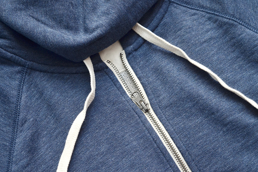 Closeup of a mass produced, generic navy blue hoodie.