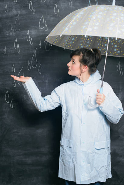 istock woman under umbrella on drawn raindrops background 917091038